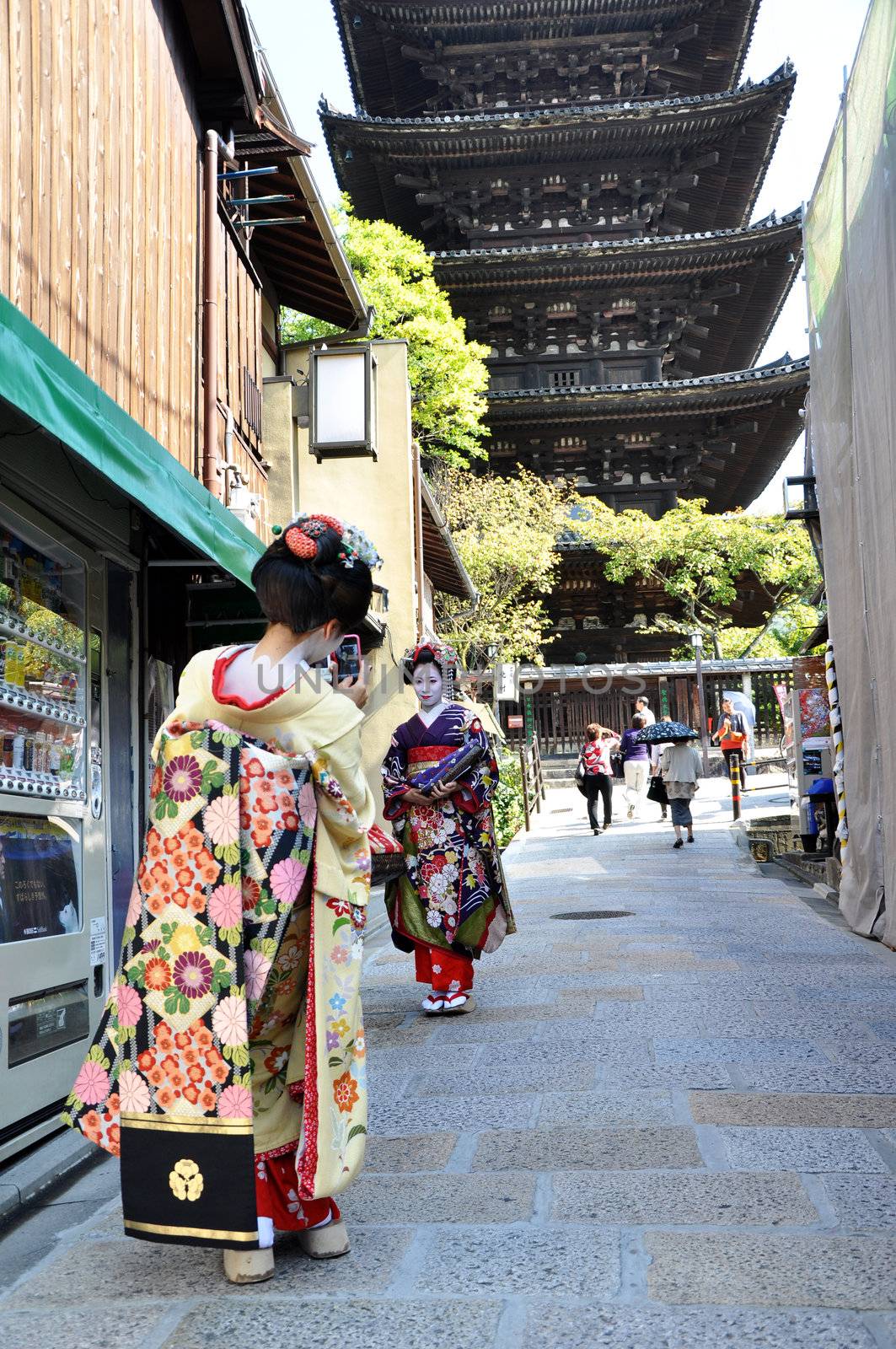 KYOTO, JAPAN - OCT 21 2012: Japanese ladies in traditional dress  on a street leading to Kiyomizu Temple on October 21 2012. Kiyomizu is a famous temple in Kyoto built in year 778.