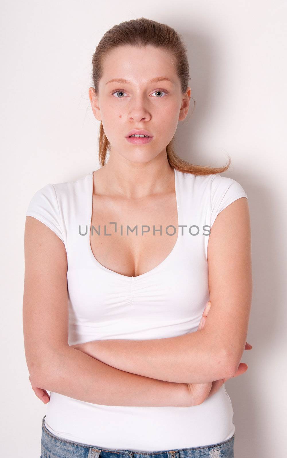 Young serious woman close to wall with shadow