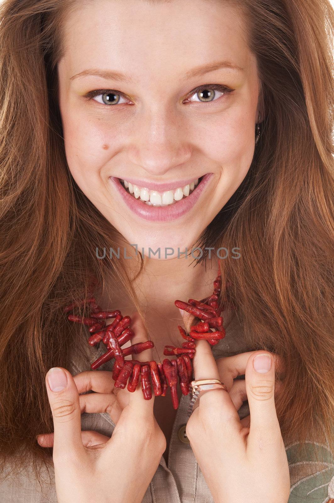 Portrait young woman is showing coral beads