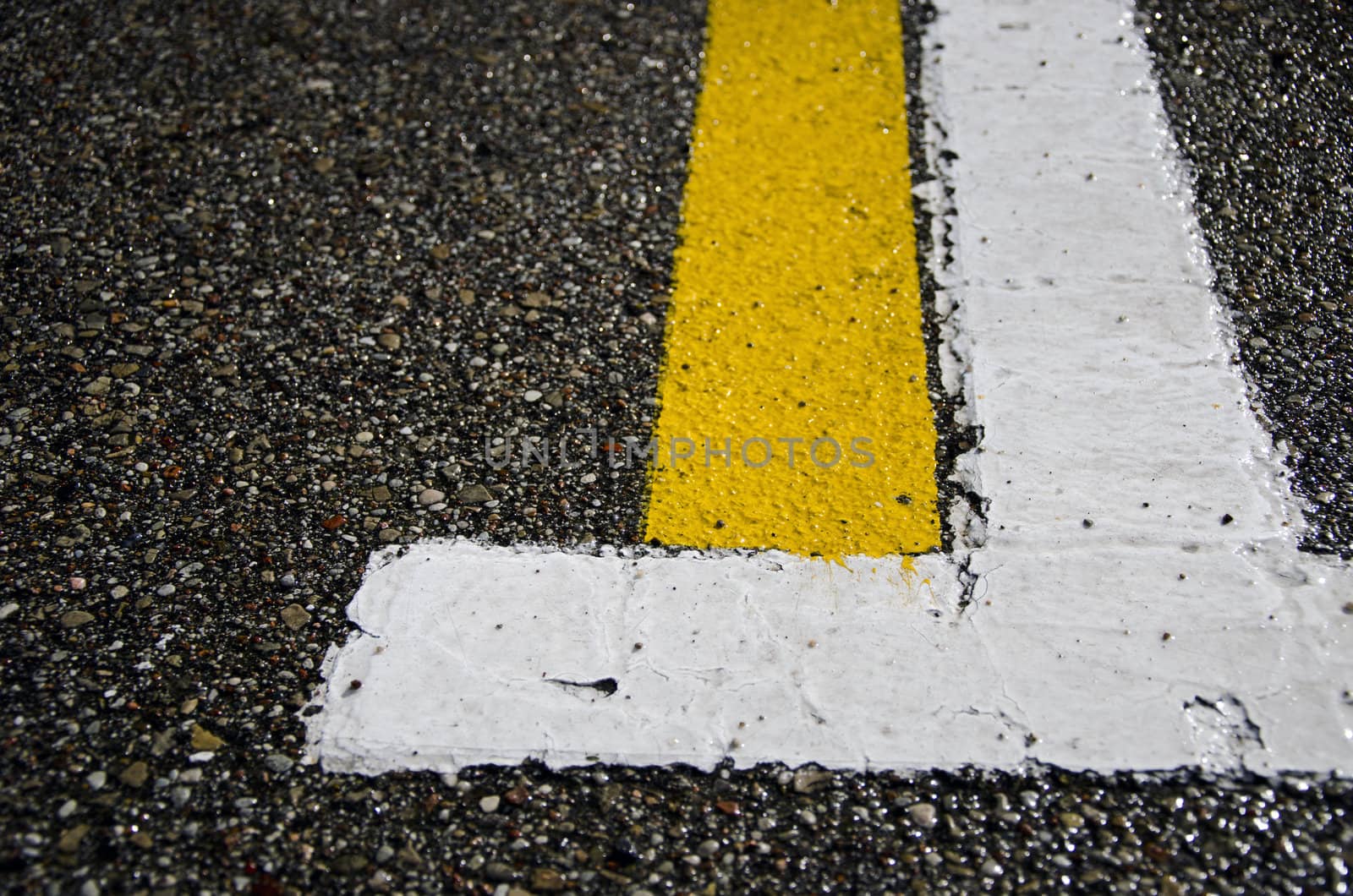 wet asphalt with white and yellow lines background
