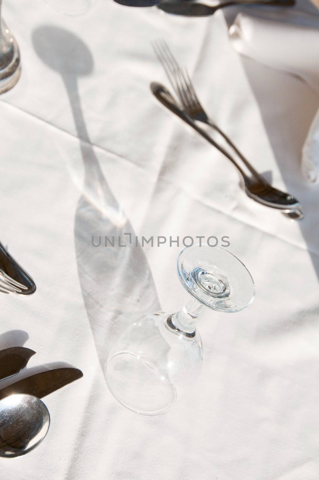 Dining tables ready for customers, outdoor evening. Shallow depth of fields, focus on the glass top.