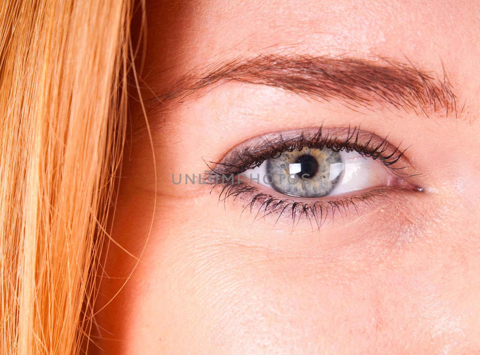Macro shot of  a red-haired woman's eye