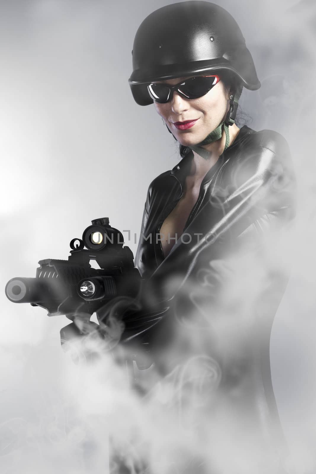 Sexy woman holding gun with smoke