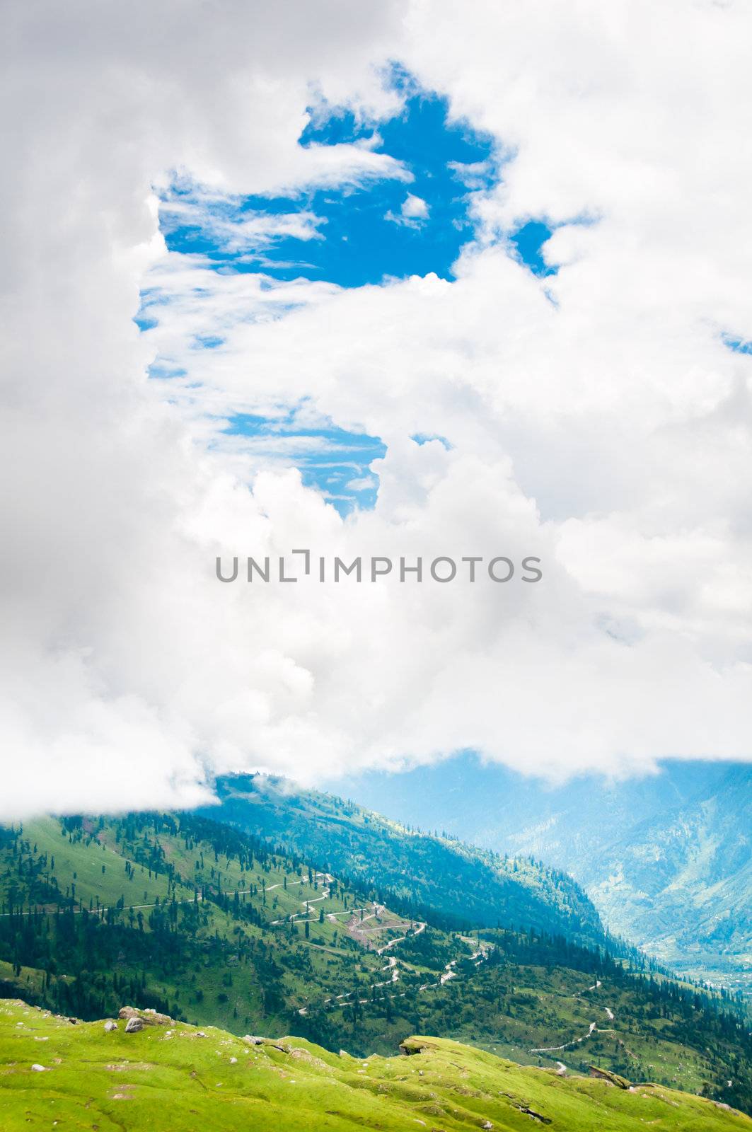 Summer landscape in mountains with serpentine road and blue sky with clouds, Himalayas