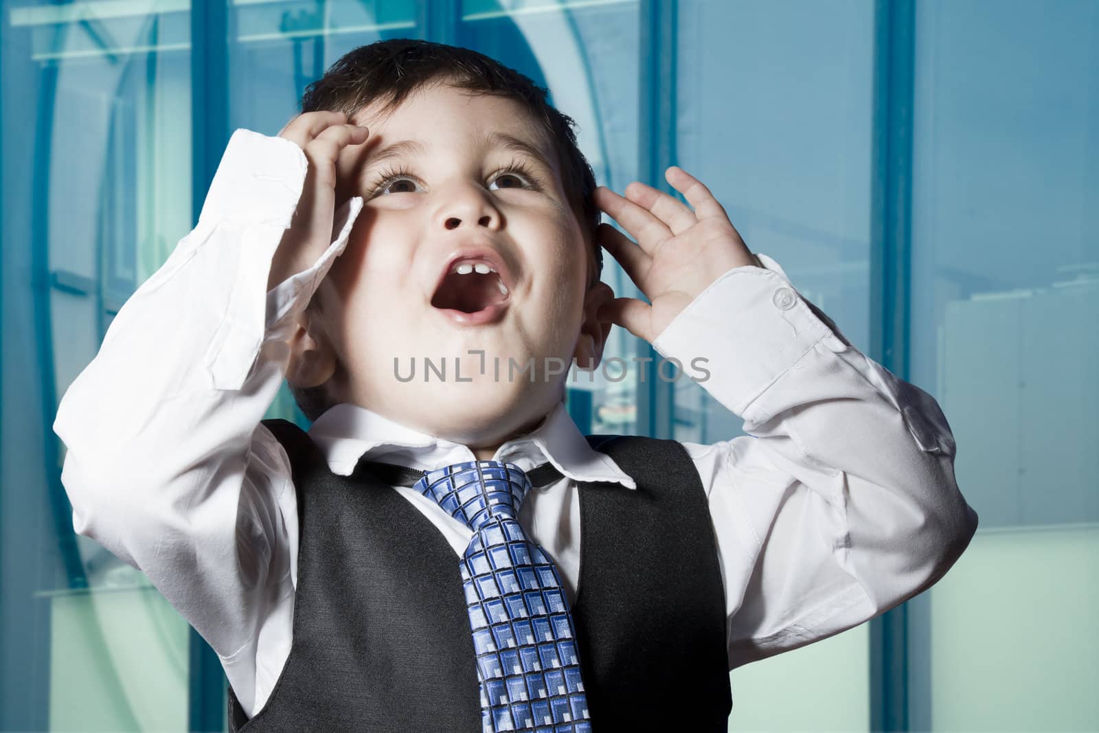 Child dressed businessman with funny face. surprise