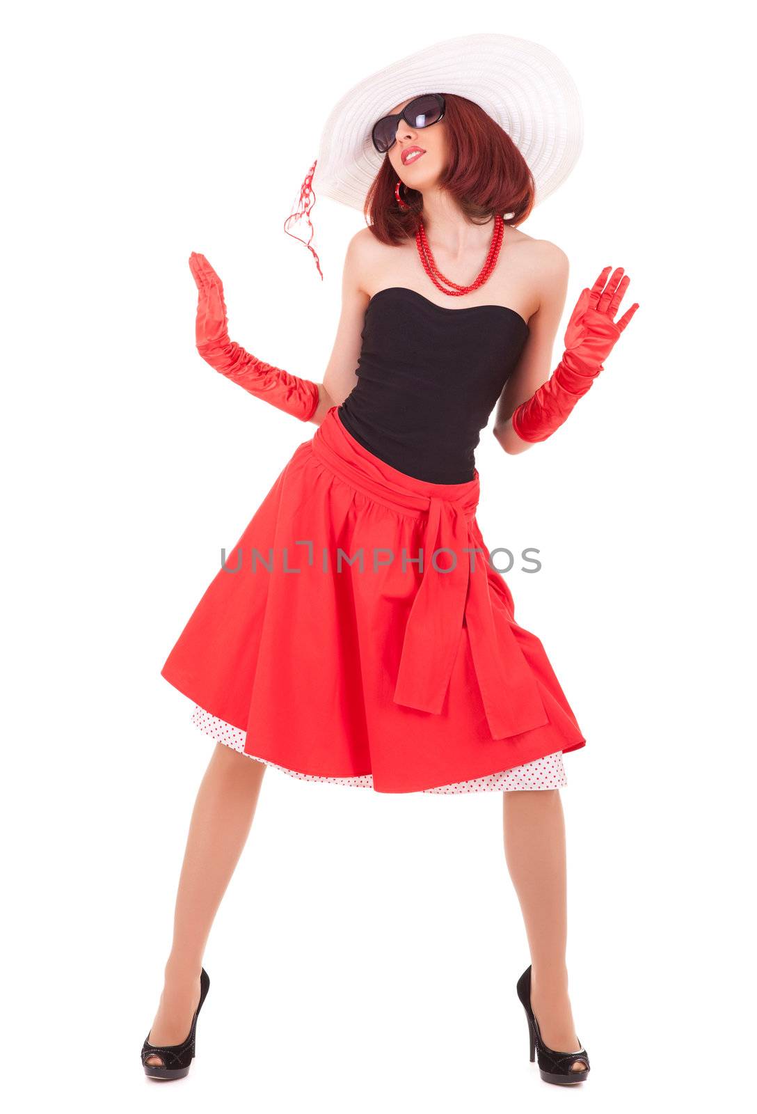 Full-length dancing girl in retro style with big hat on white background