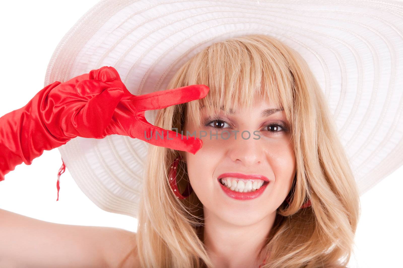 Playful fashion girl in retro style with bright make-up and big hat on white background