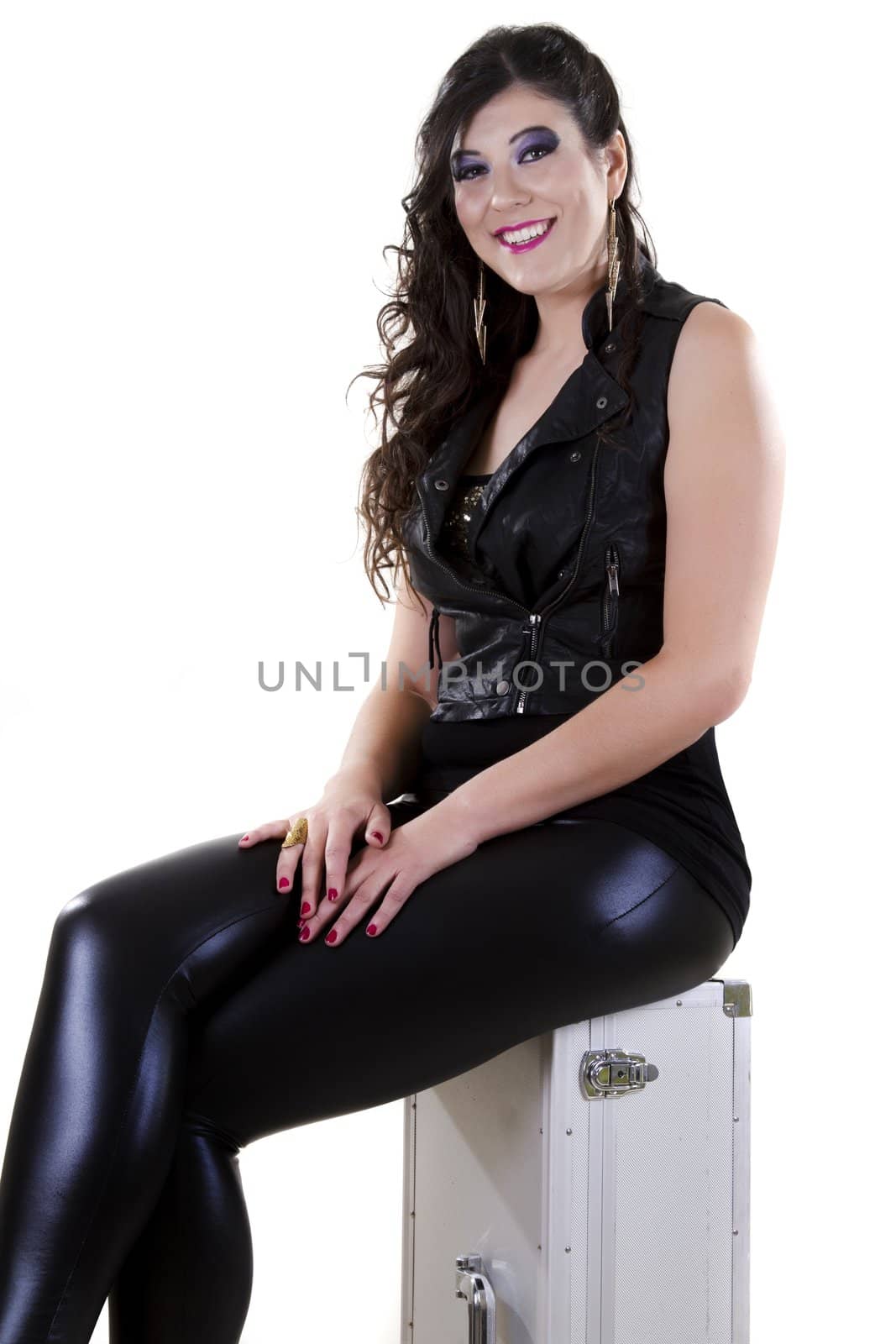 View of a beautiful girl in dark leather clothes against a white background.