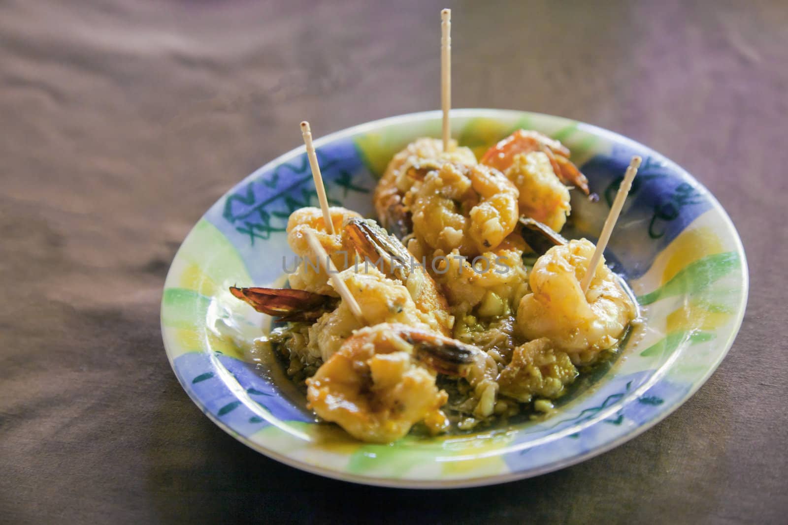 Horizontal capture of King prawn shrimps in crushed garlic butter, a generic dish served worldwide even in the land of hot curries - India