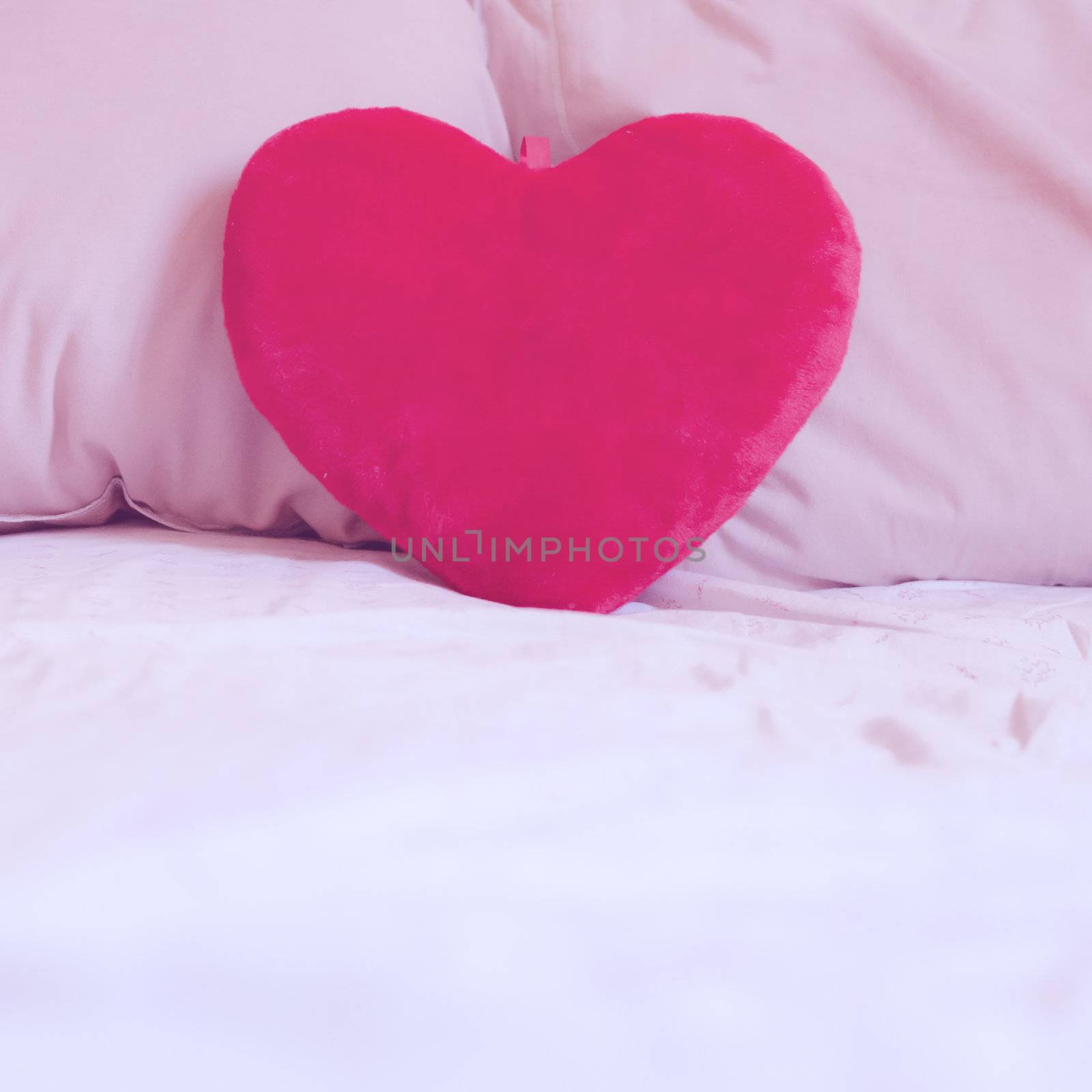 heart pillow on the bed by peus