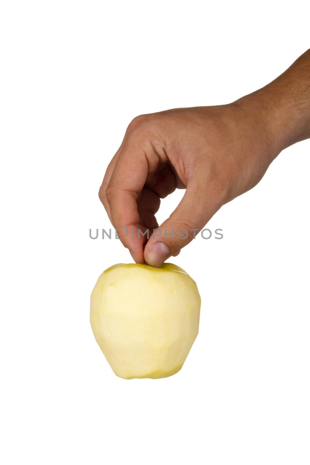 Peeled Golden Delicious apple in a hand isolated on a white background.