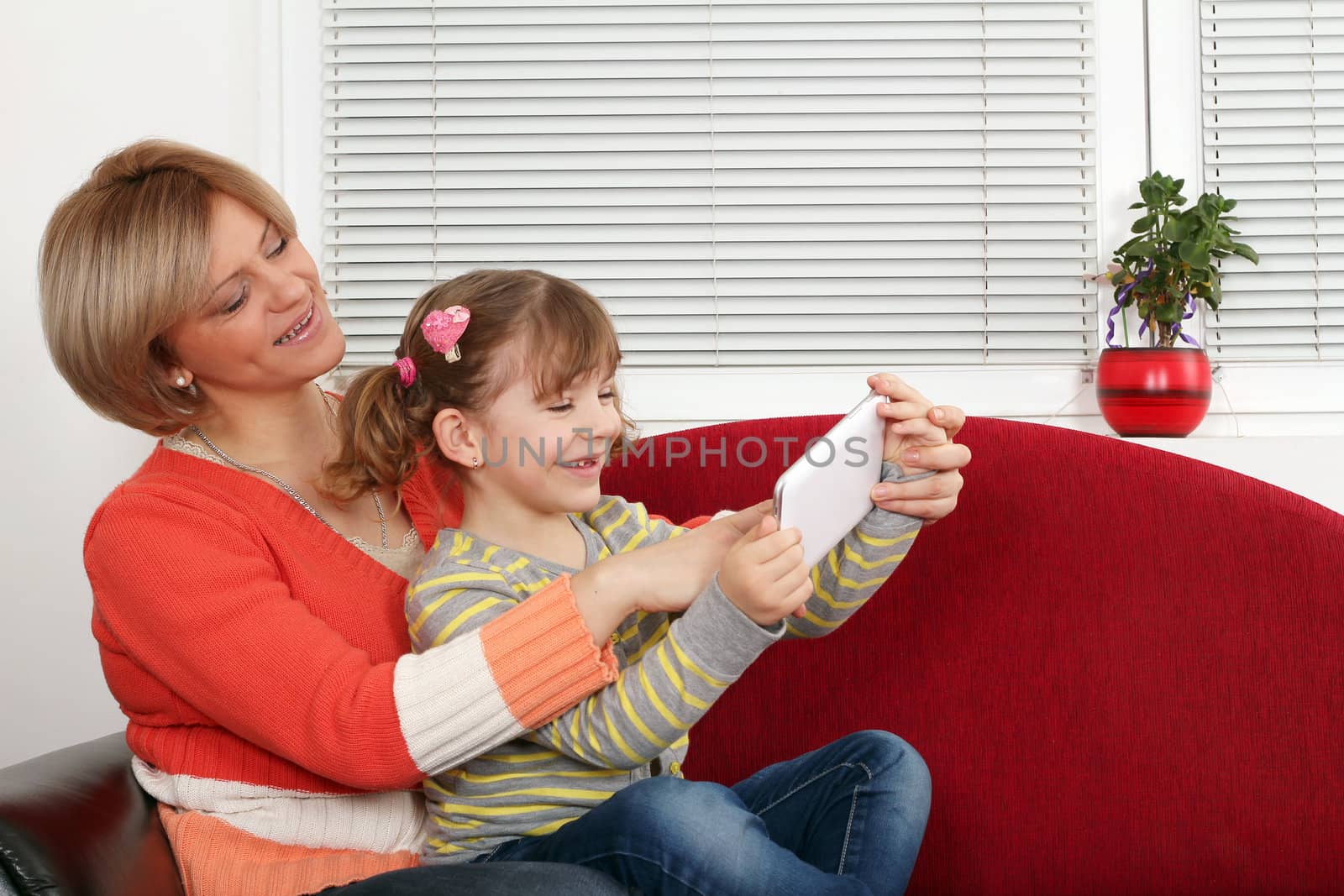 happy mother and daughter fun with tablet pc by goce