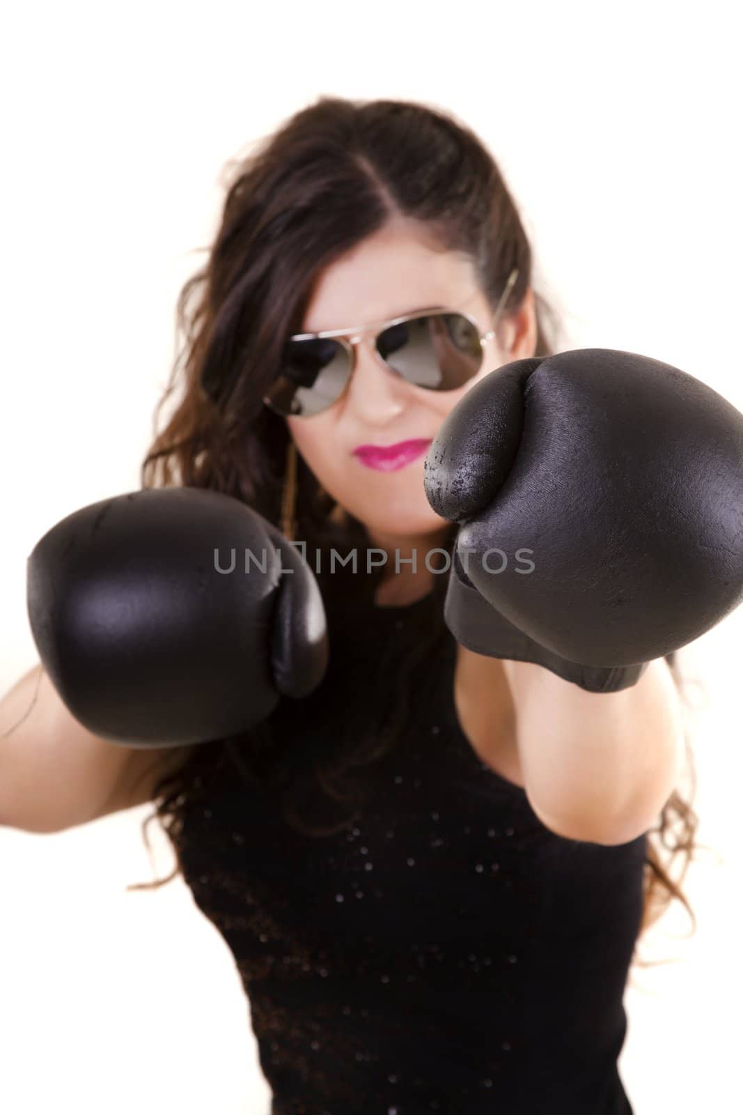 View of a beautiful girl in dark leather clothes against a white background with boxing gloves.