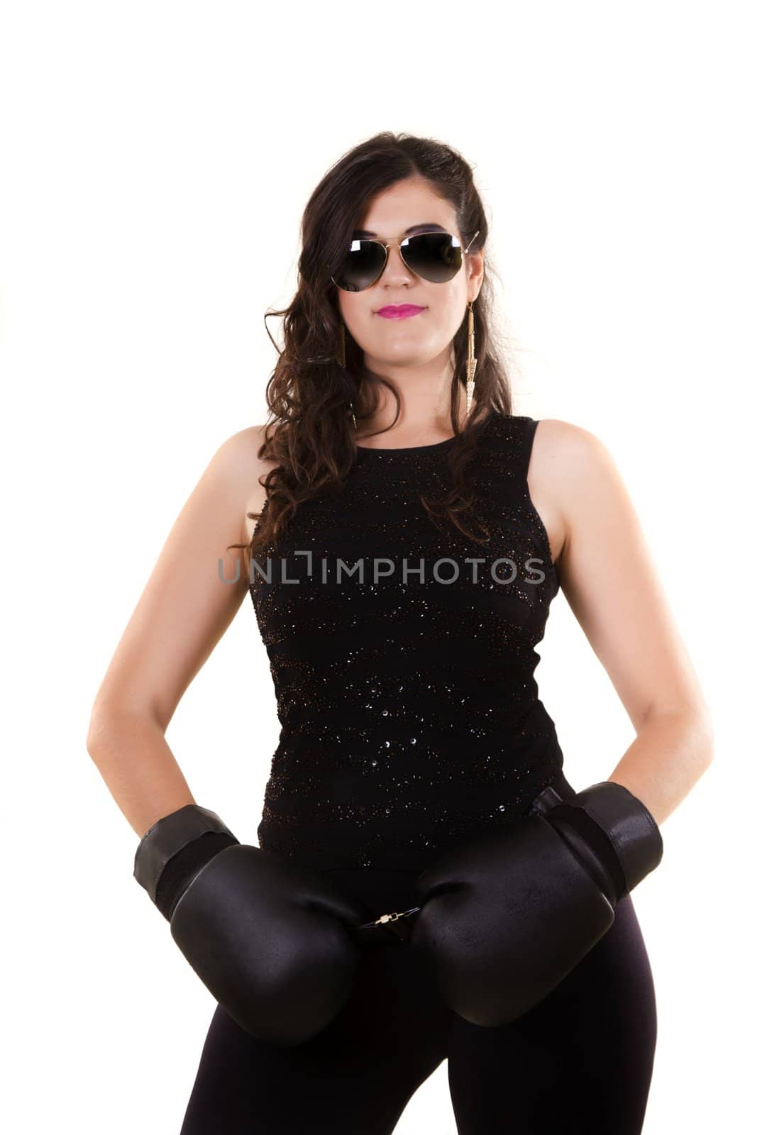 View of a beautiful girl in dark leather clothes against a white background with boxing gloves.