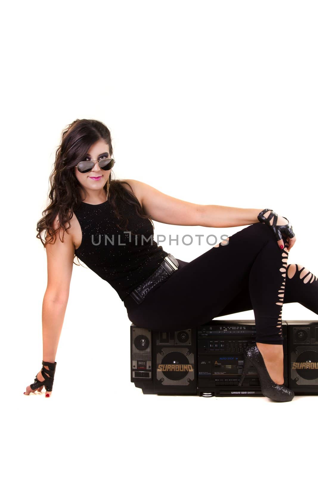 beautiful girl in dark leather clothes holding a large retro radio by membio