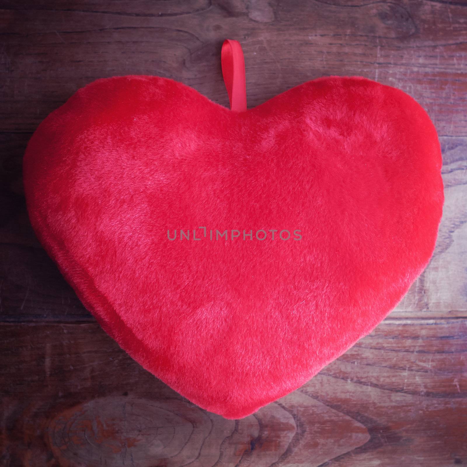 heart pillow on wood by peus