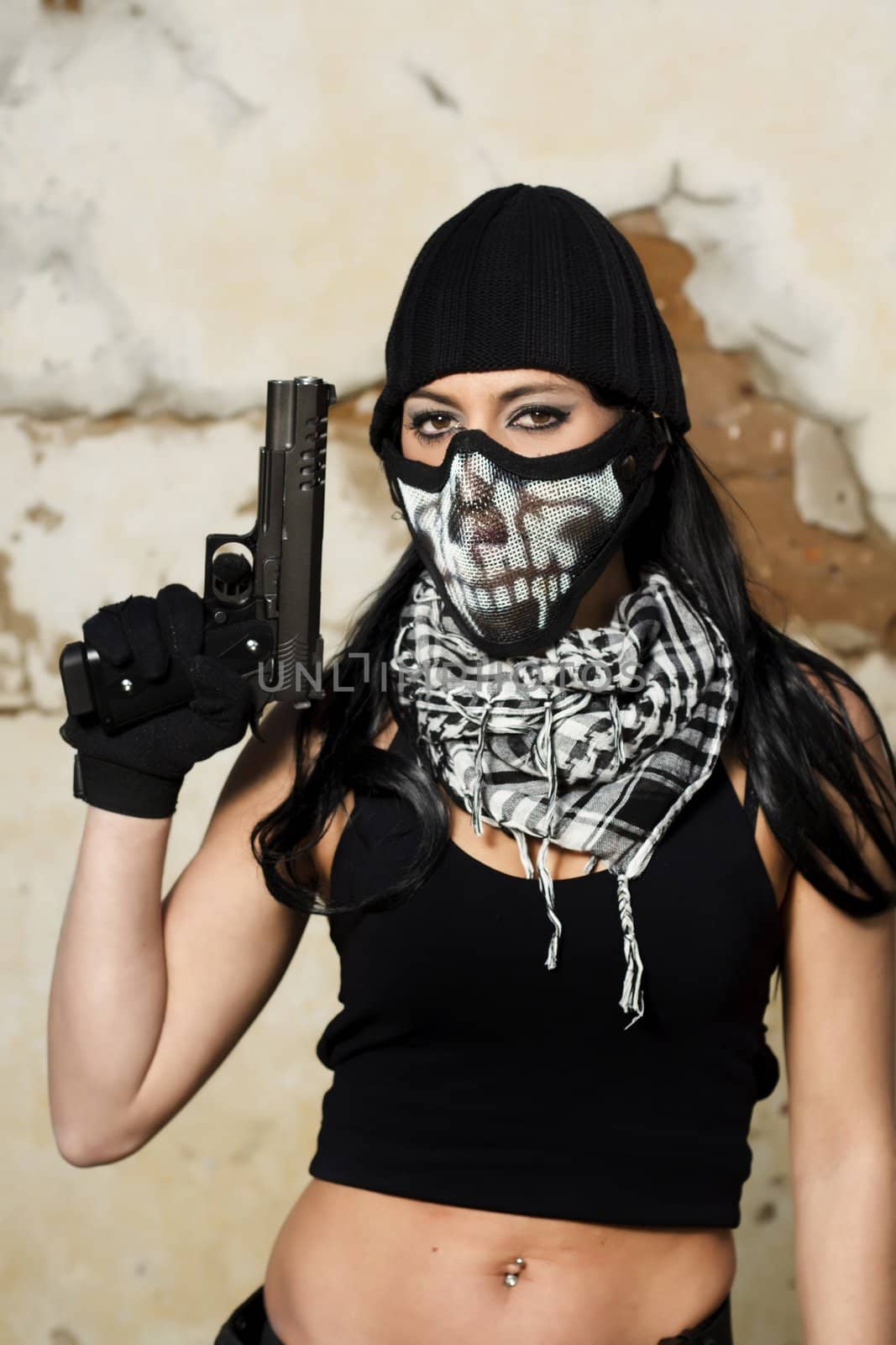 View of a beautiful action girl holding a weapon and mask, in a outdoor location.