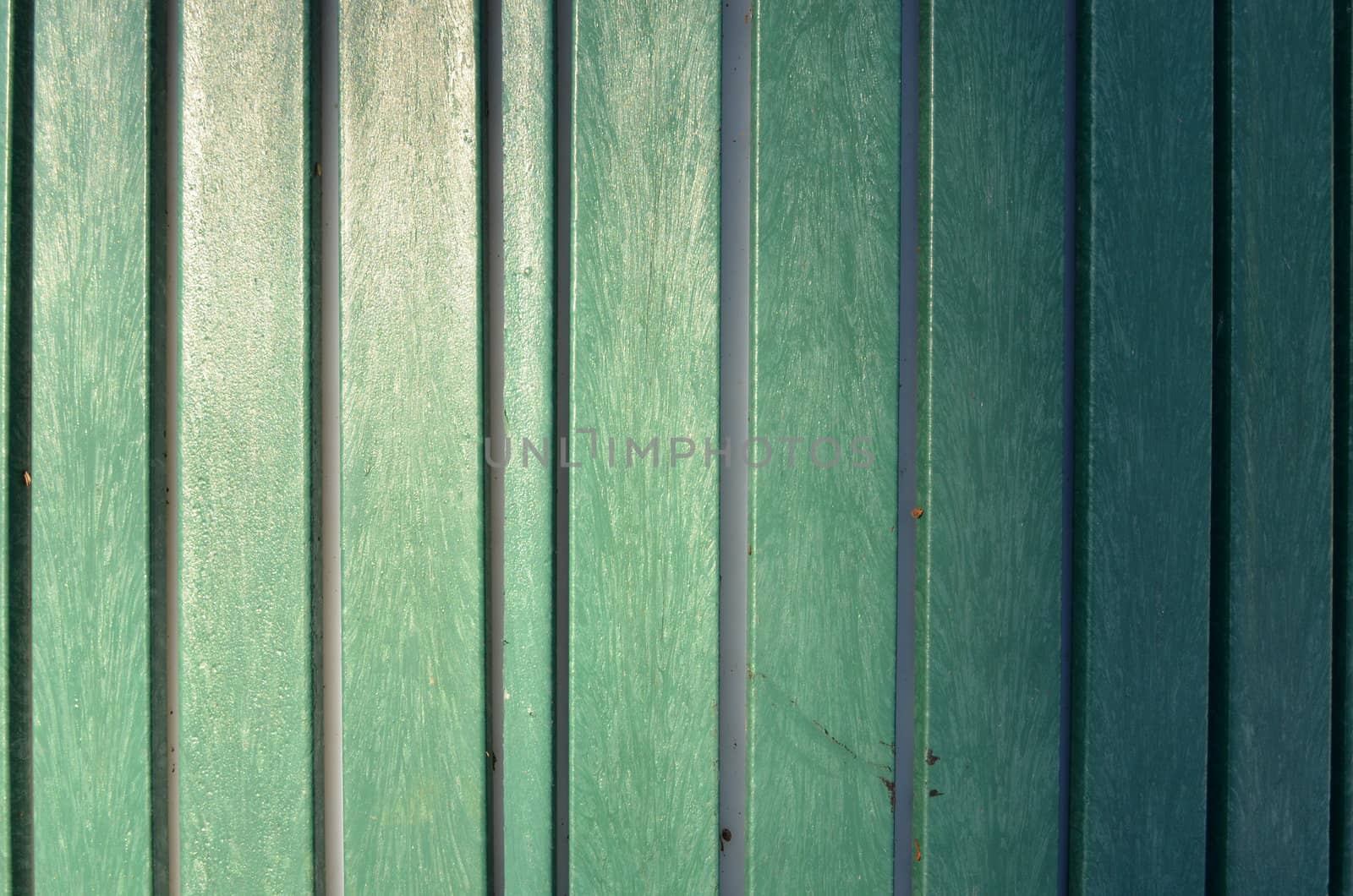green plastic wall horizontal lines and shadow background closeup.