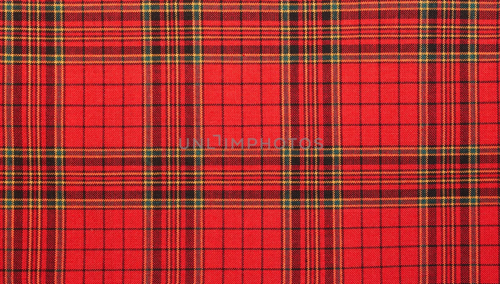 Textiles. Bright red plaid  fabric as natural background