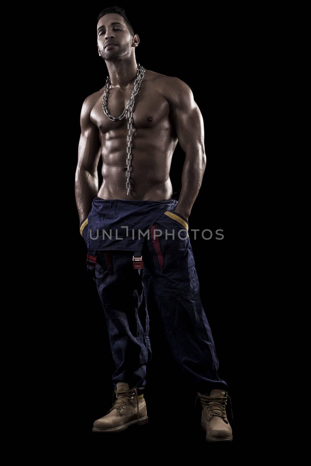 muscled man on a black background by membio