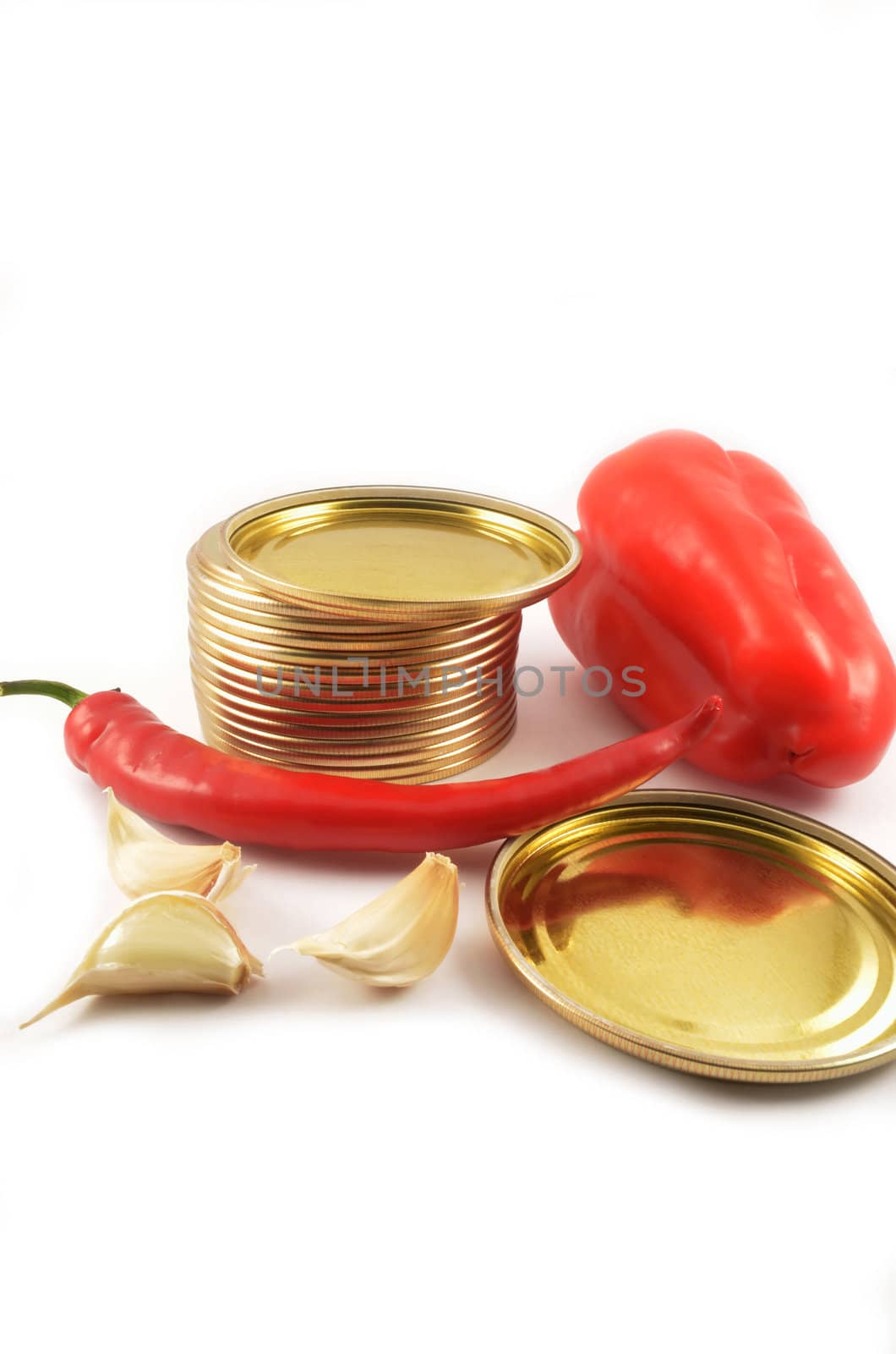 Sweet and sharp red peppers, garlic and metal covers for cans