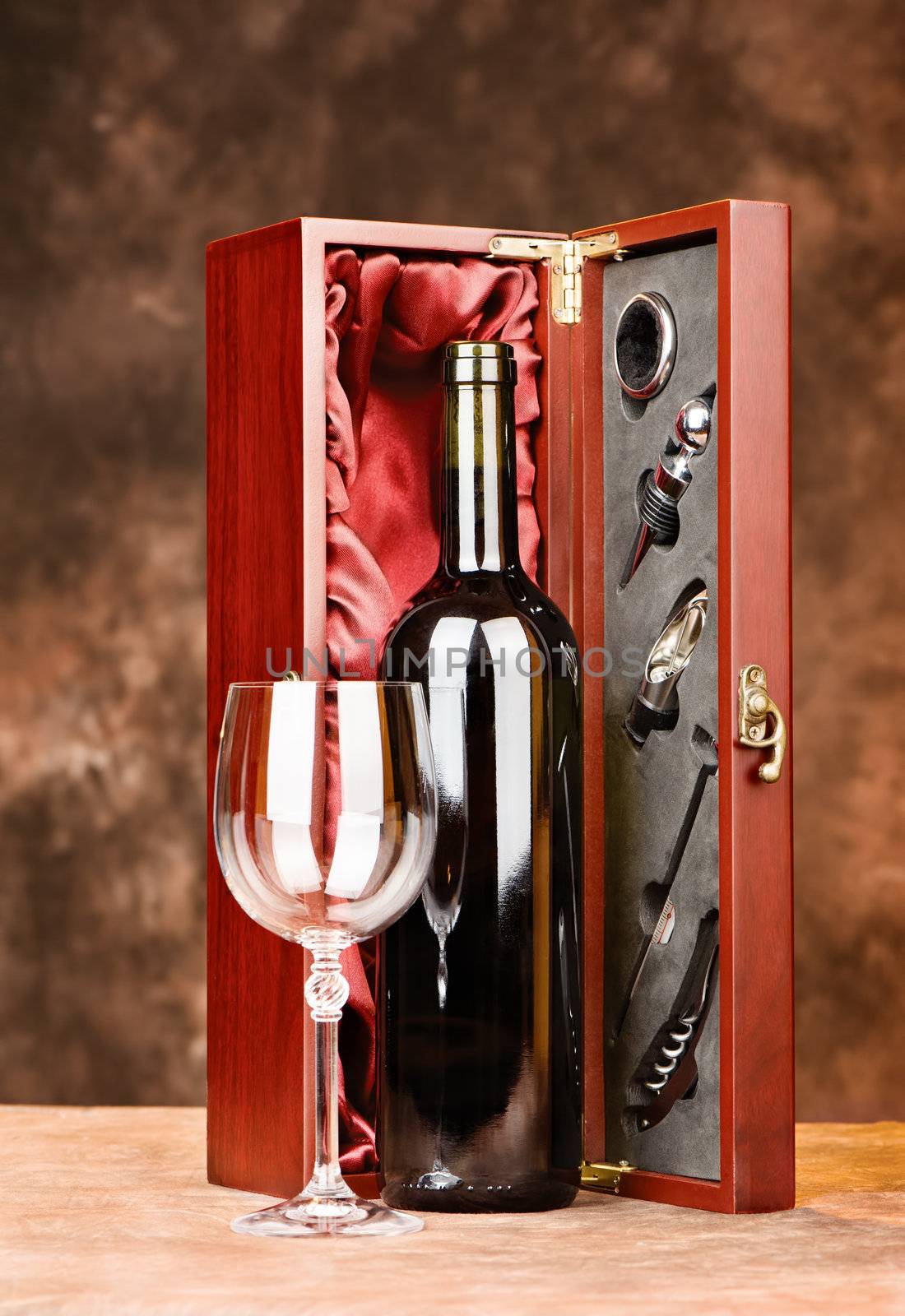 Wine bottle and cup in front of wooden wine case