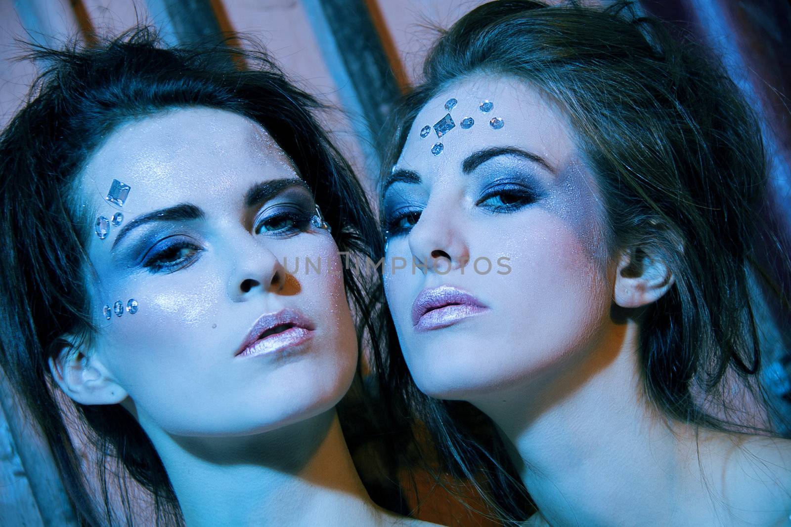 two beautiful girls in blue and glitter make up portrait