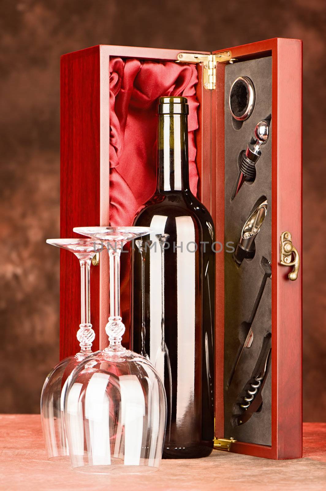 Wine bottle and cups in front of wooden wine case