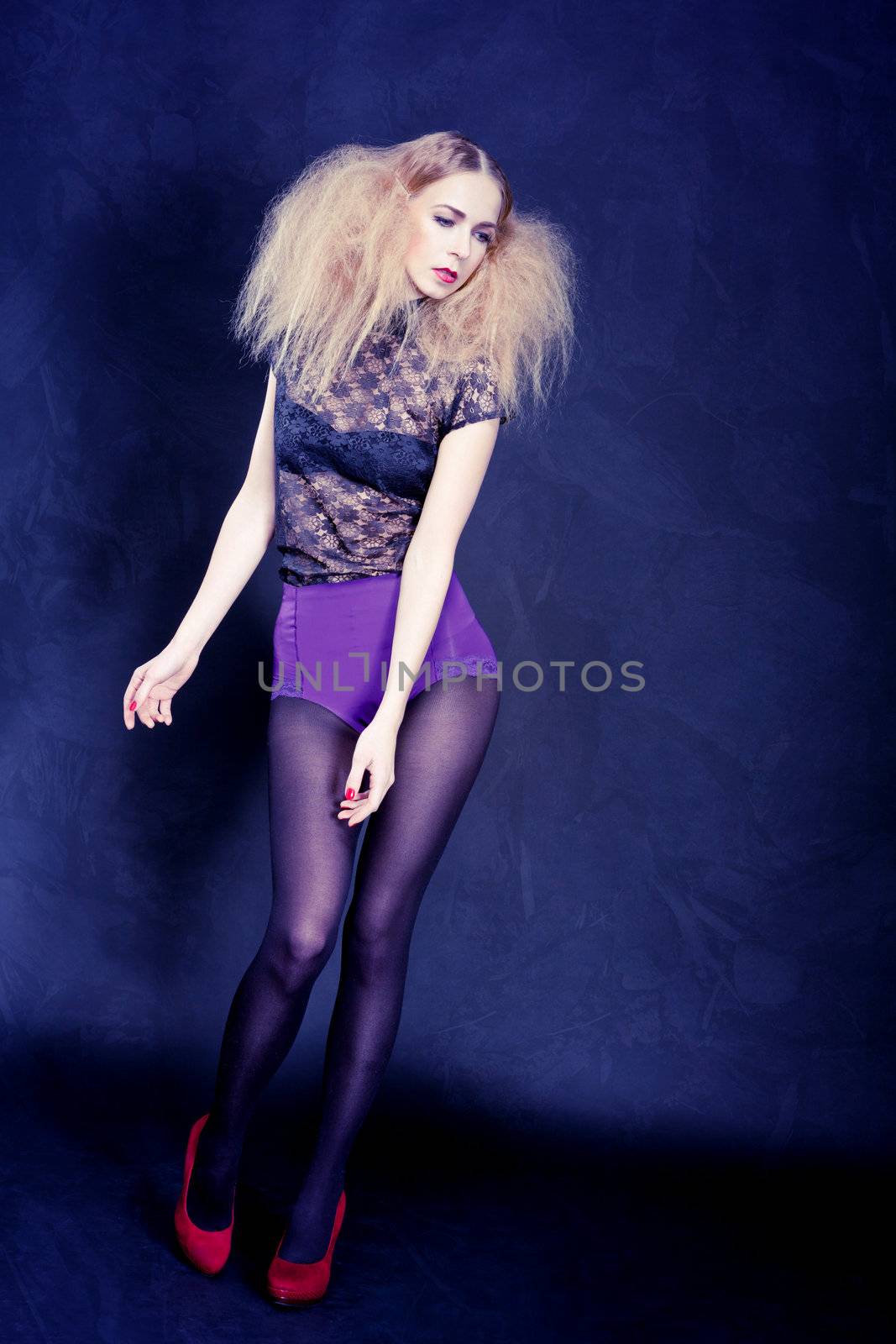 attractive blonde woman with big hair and modern styling fashion posing