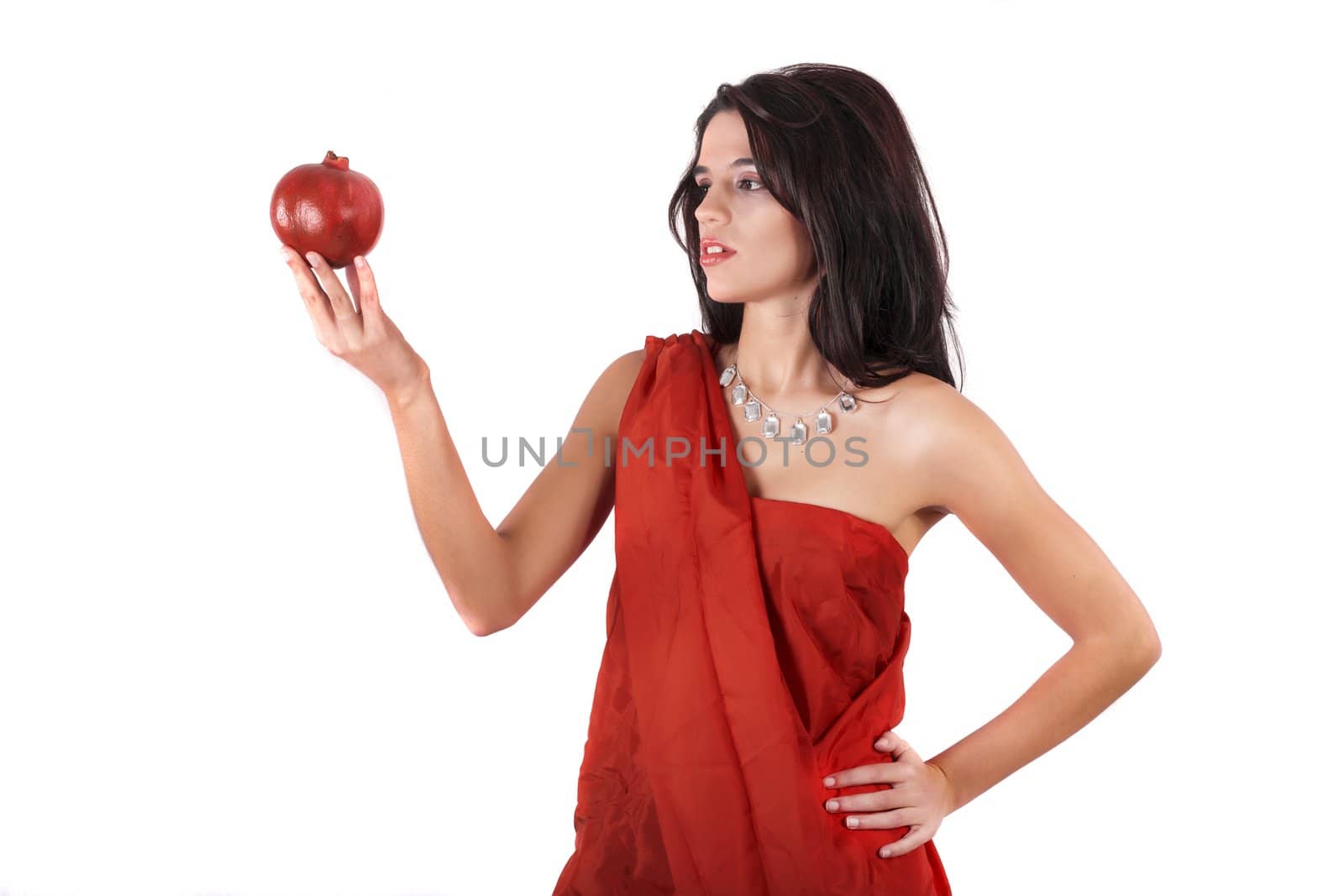 View of a beautiful girl holding a pomegranate.