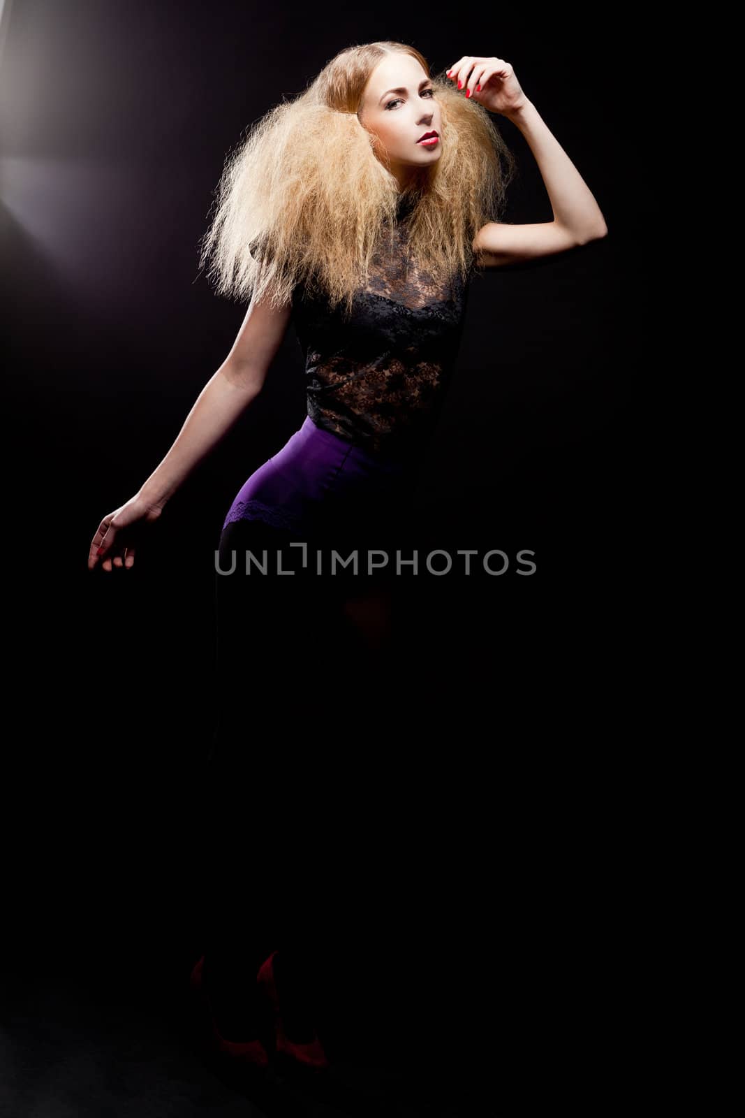 attractive blonde woman with big hair and modern styling fashion posing