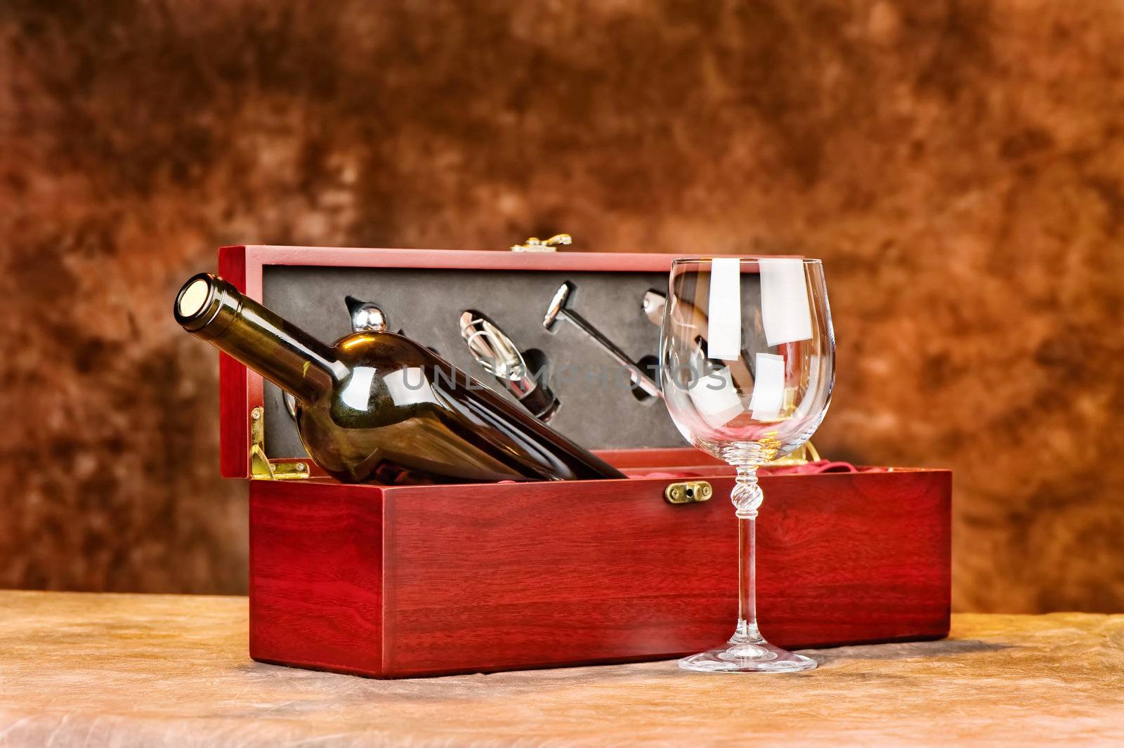 Wine cup in front of vintage wooden wine case