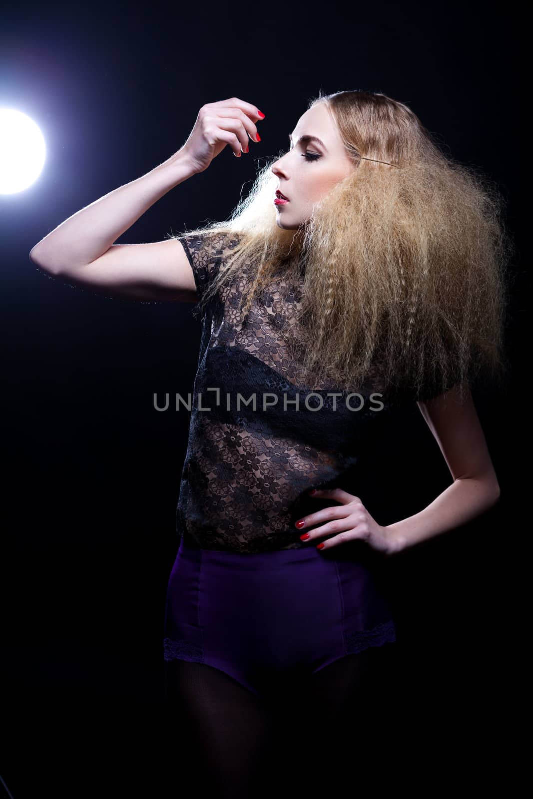 attractive blonde woman with big hair and modern styling fashion posing