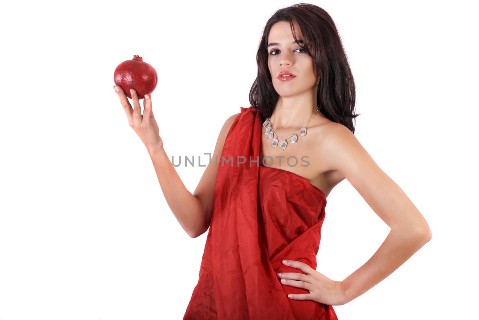 View of a beautiful girl holding a pomegranate.