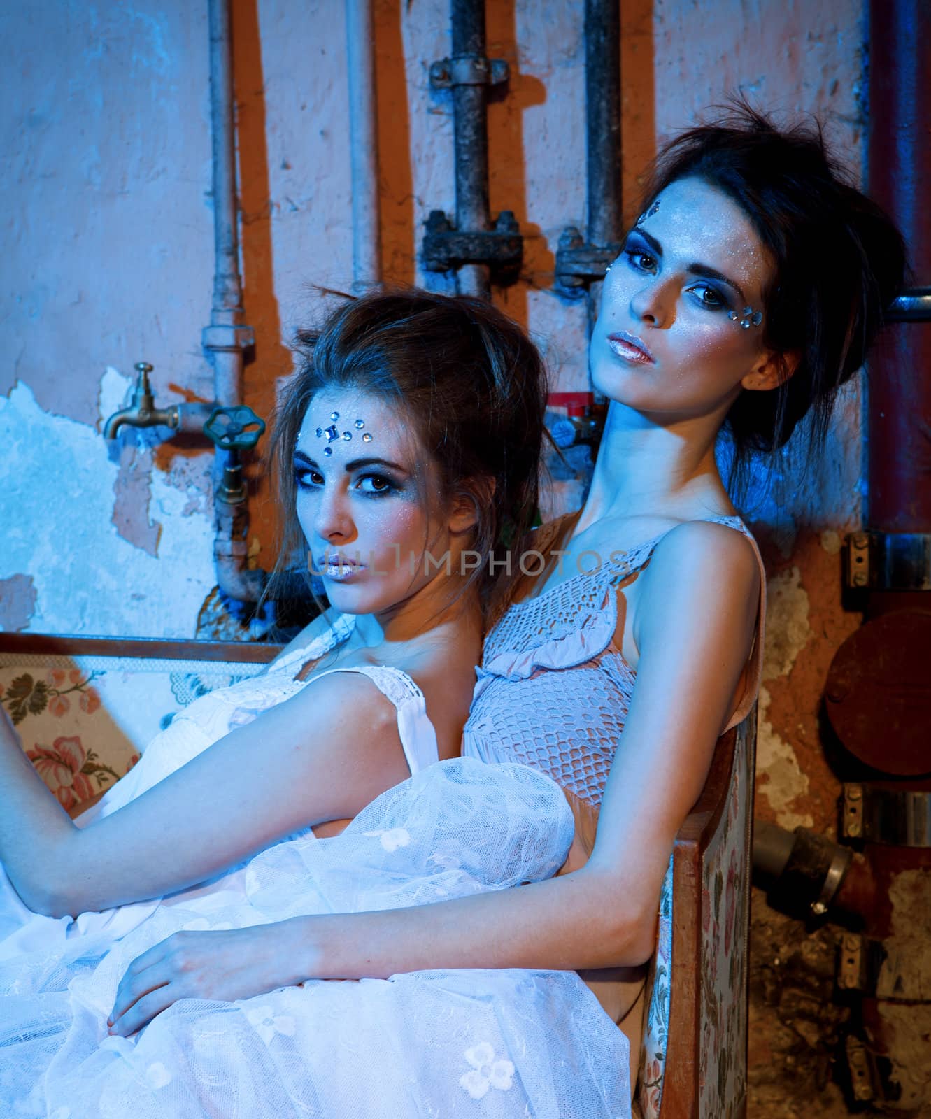 two beautiful girls in blue and glitter make up portrait