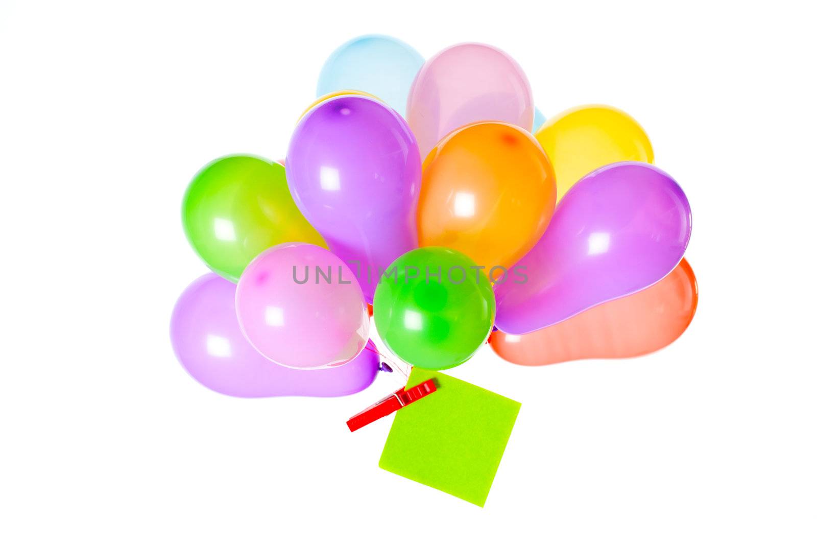 Bunch of balloons with a note pinned to the knot with a peg on white background
