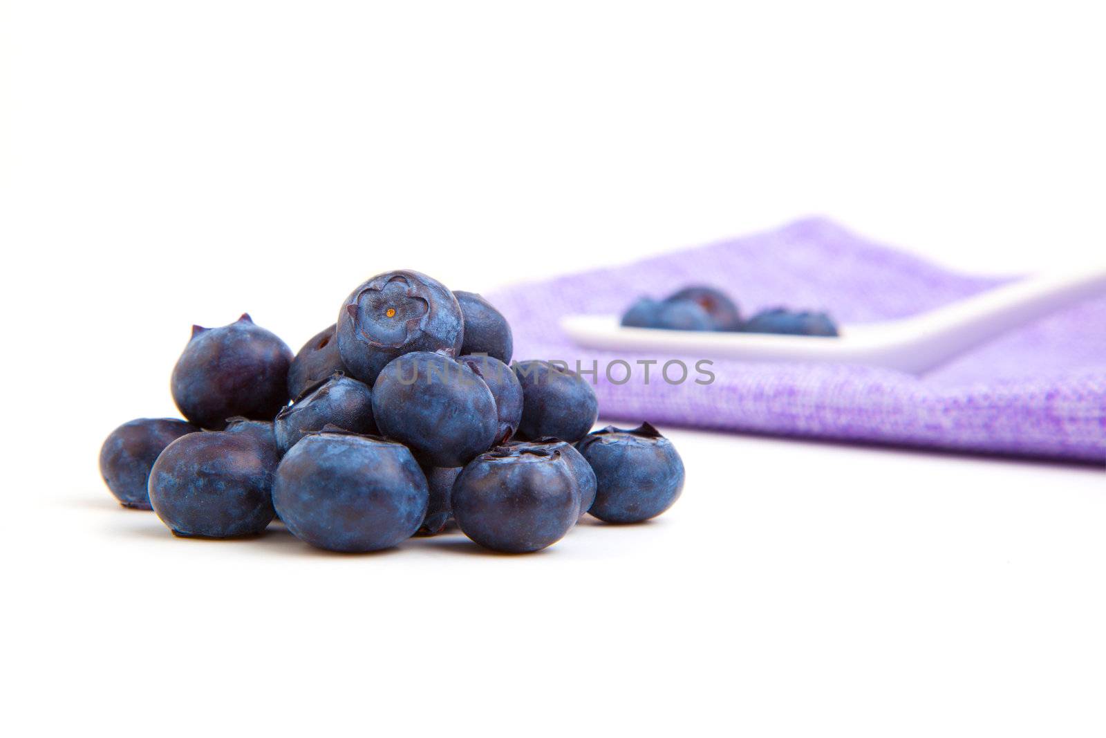 fresh blueberry with porcelain spoon and serviette