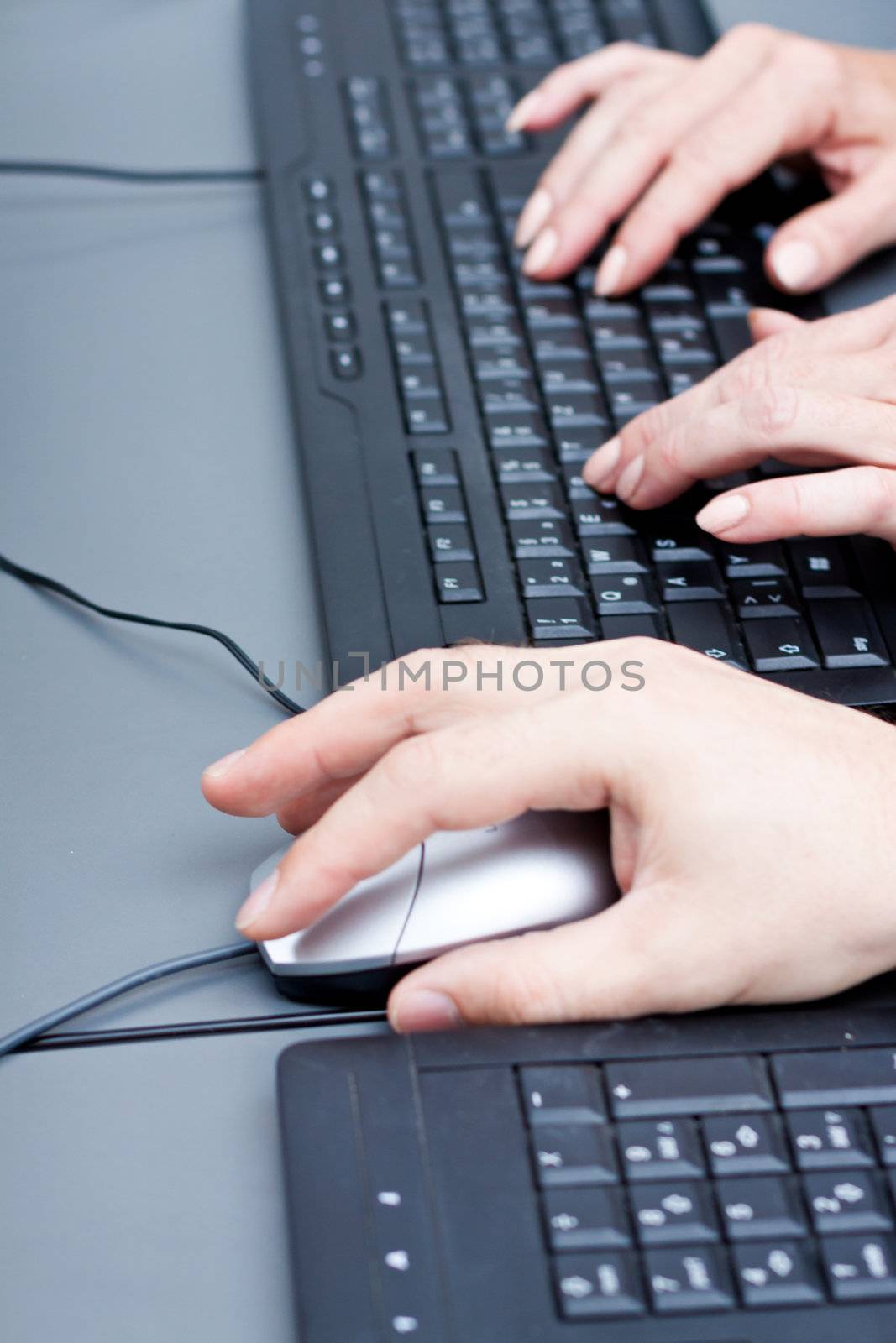 male hand on keyboard typing and scroll mouse on office desk