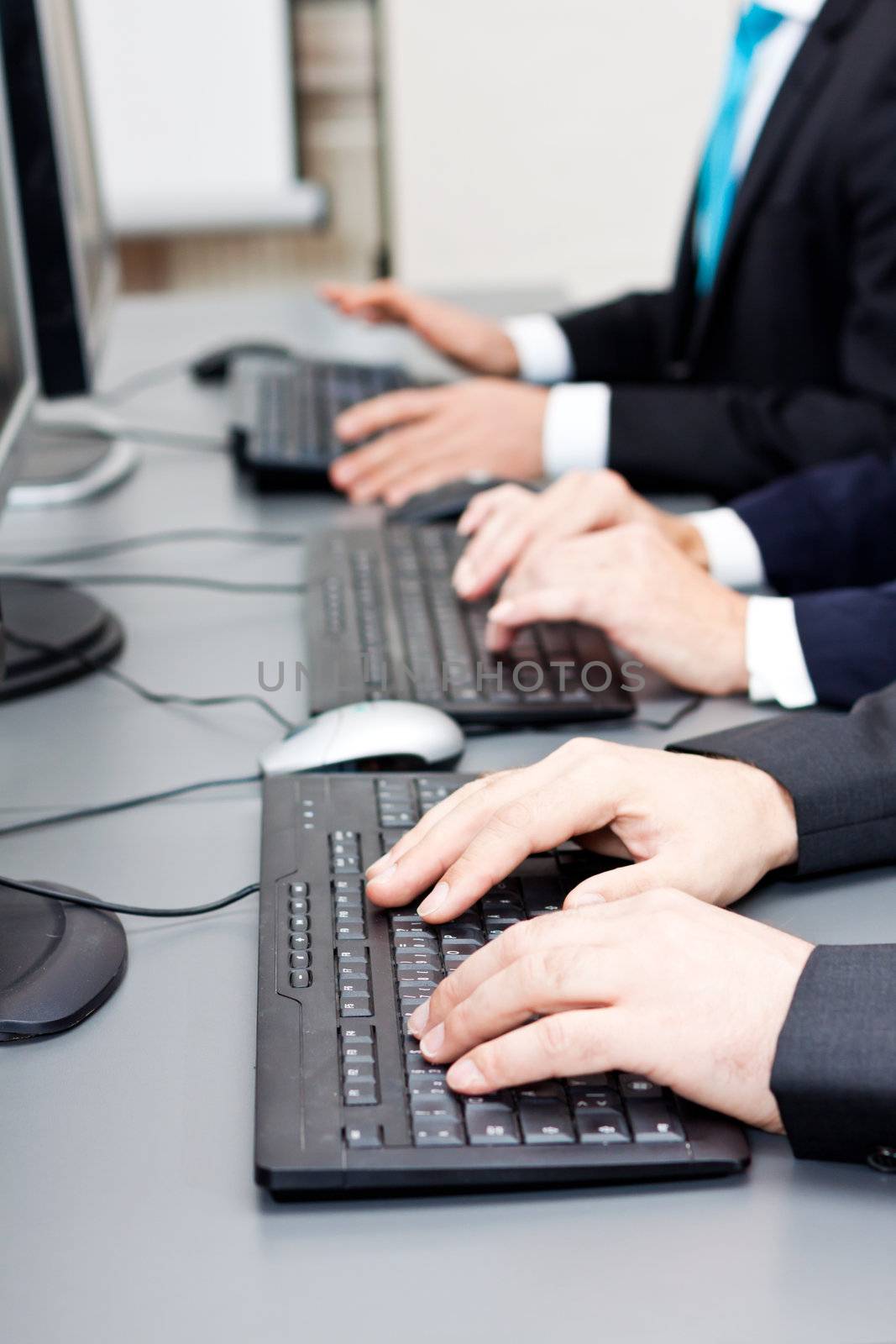 male hand on keyboard typing and scroll mouse on office desk