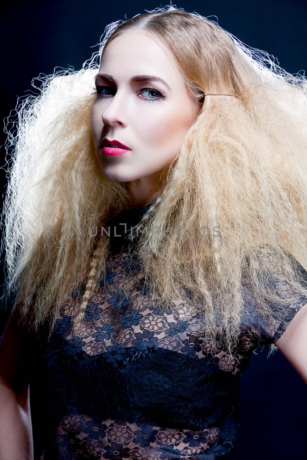 sexy blond woman with red lips and hairstyle on black background