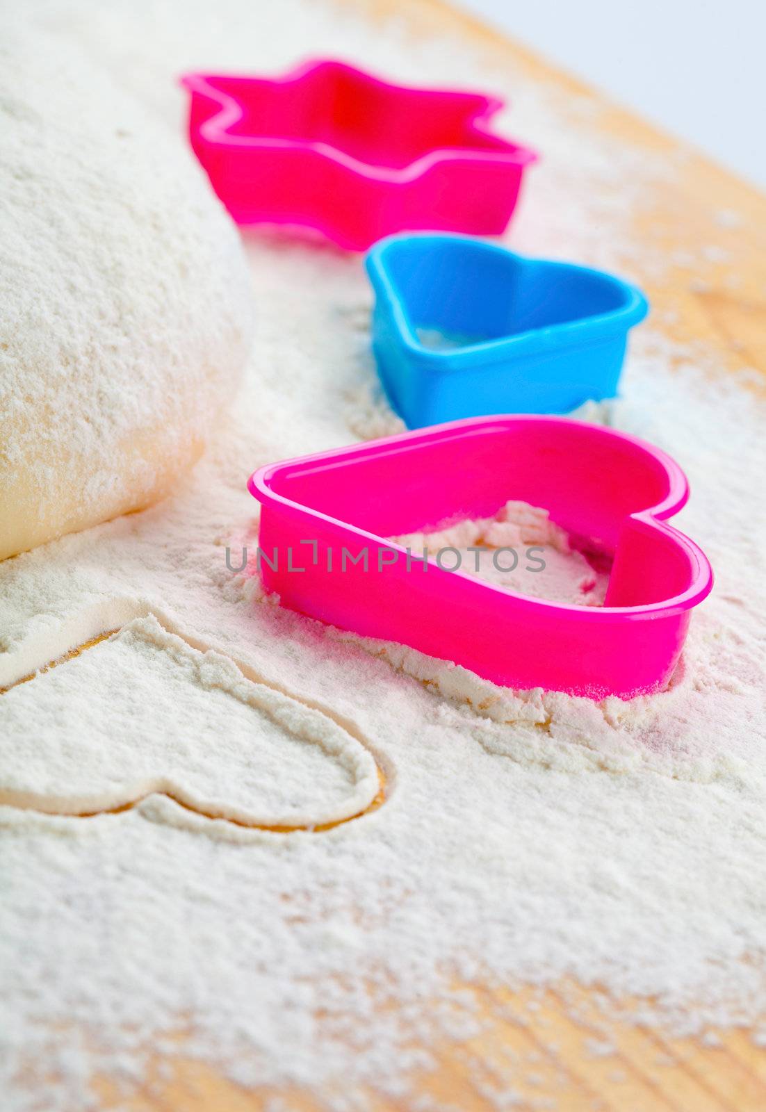 heart shaped cookie cutter on flour  by motorolka