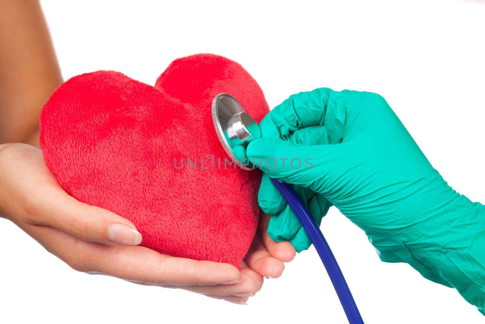 A doctor with stethoscope examining red heart, isolated on white