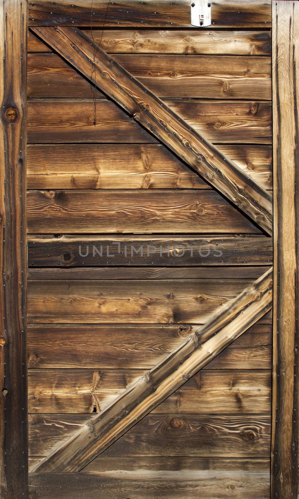 Old barn door wood textured with slanted braces