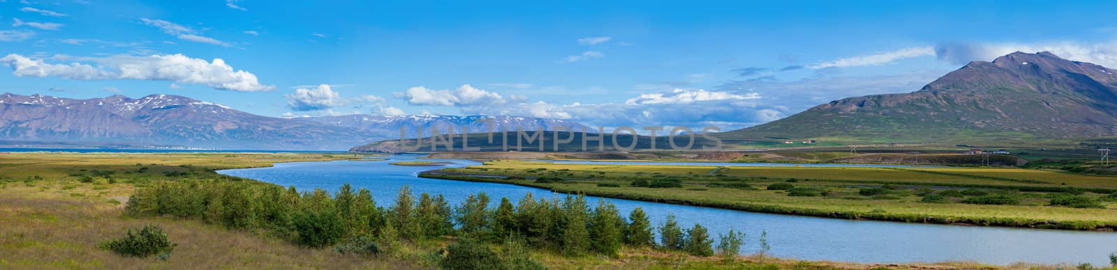 Beautiful landscape. Iceland. Mountain, river, forest, blue sky. Panorama