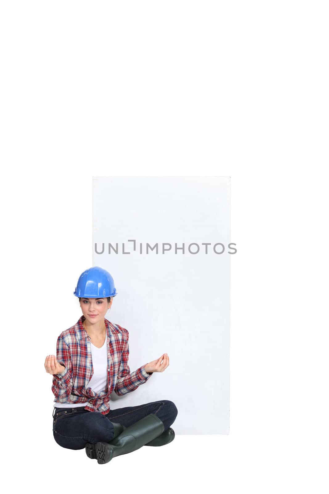 A female construction worker in the lotus position.