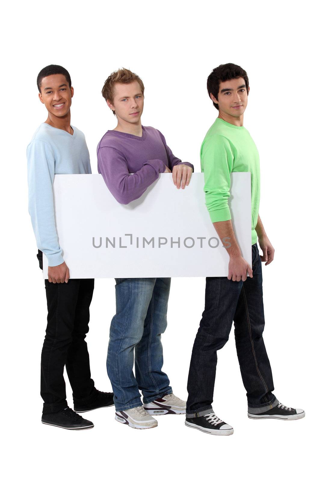Three young men carrying a blank board by phovoir