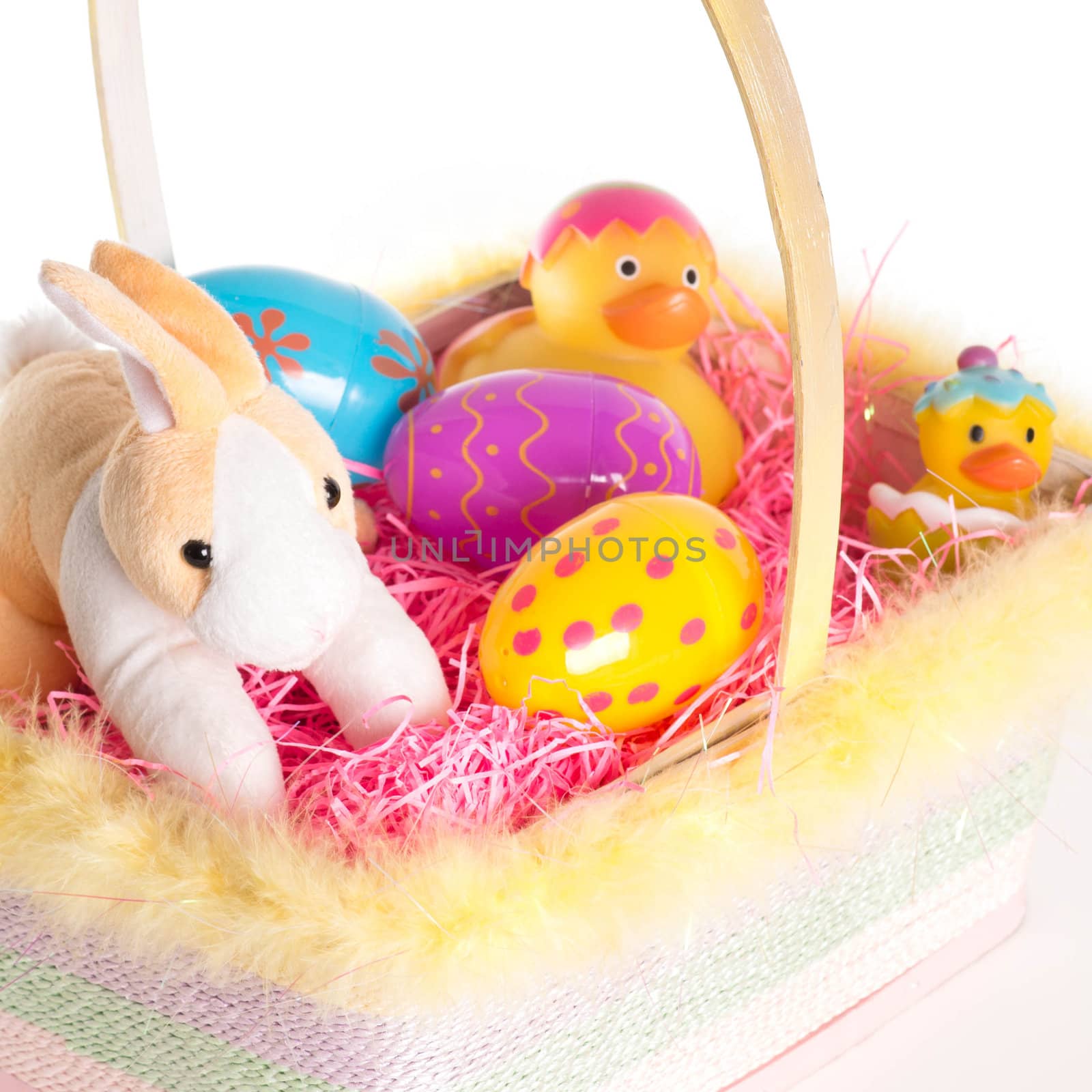 Easter Bunny and Easter basket with eggs and rubber ducks. Isolated on white background