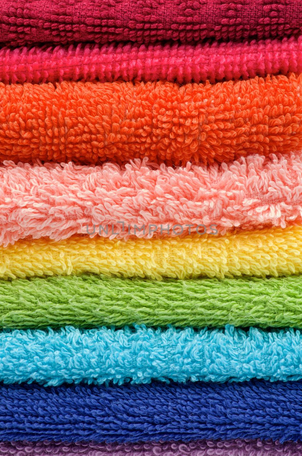 Background of Stacked Rainbow Colored Towels closeup
