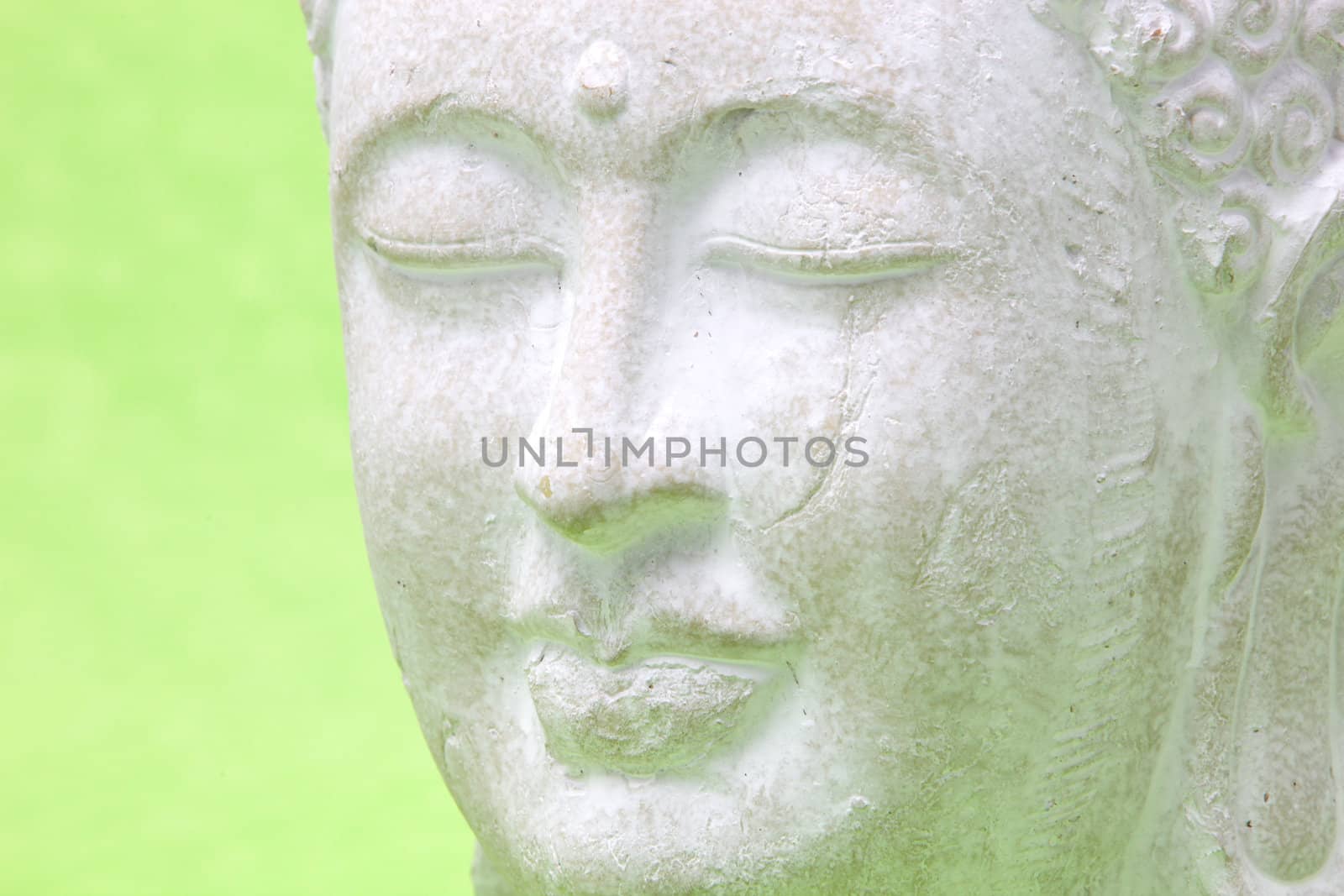 Head of smiling peaceful yoga white statue, close up