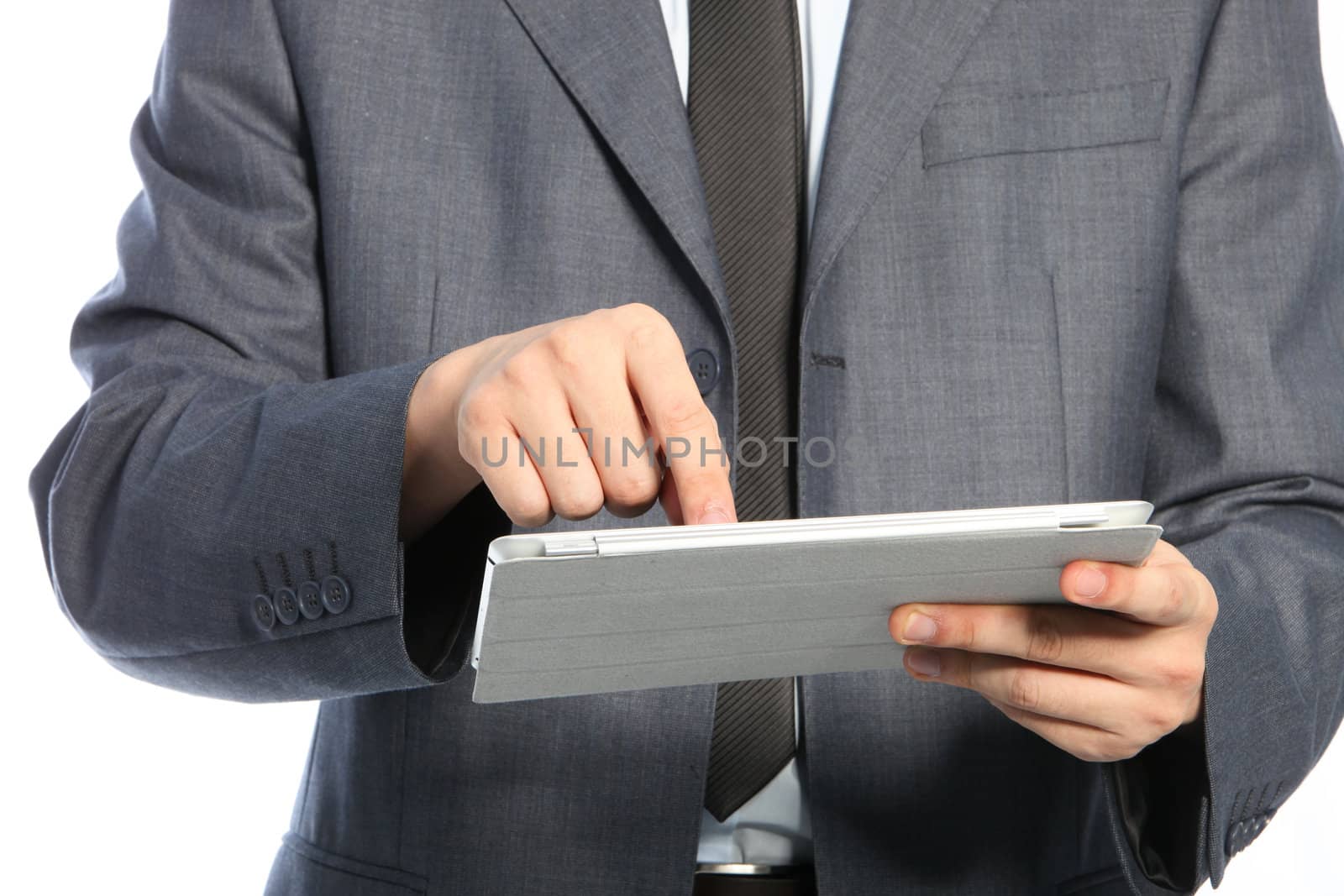 Torso of a businessman wearing business suit and using a PC tablet, close up